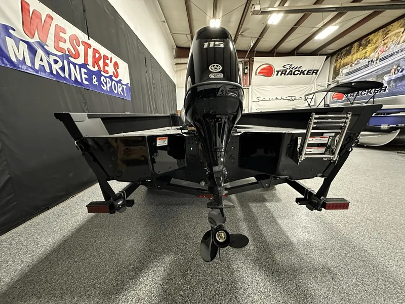 Slide: The Image of 2025 Alumacraft Competitor 185X Tiller boat displayed indoors at Westre's Marine & Sport. - 6