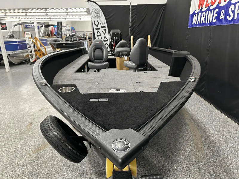Slide: The Image of 2025 Alumacraft Competitor 185X Tiller boat in showroom, featuring spacious interior and modern design. - 8