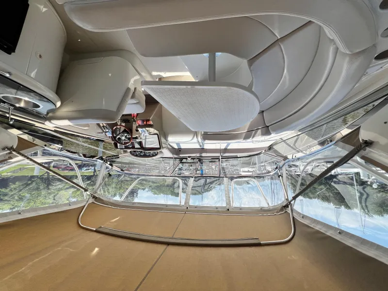 Slide: The Image of Interior of a 2002 Regal Commodore 4260 yacht, featuring sleek seating and modern controls. - 10