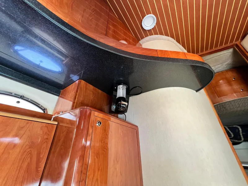 Slide: The Image of Luxurious interior of 2002 Regal Commodore 4260 yacht with wood cabinetry and modern design. - 16