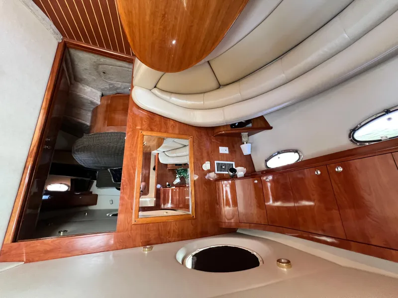 Slide: The Image of Interior of 2002 Regal Commodore 4260 yacht with wood cabinetry and plush seating. - 20