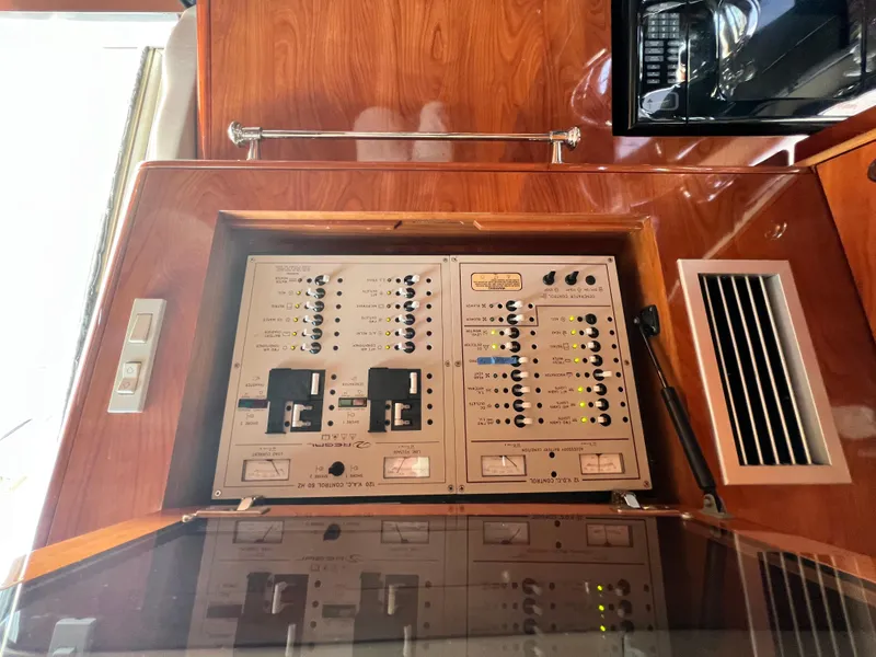 Slide: The Image of Electrical panel inside a 2002 Regal Commodore 4260 yacht, featuring switches and controls. - 22
