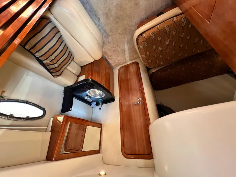 Slide: The Image of Interior of 2002 Regal Commodore 4260 yacht with wood accents and seating area. - 24