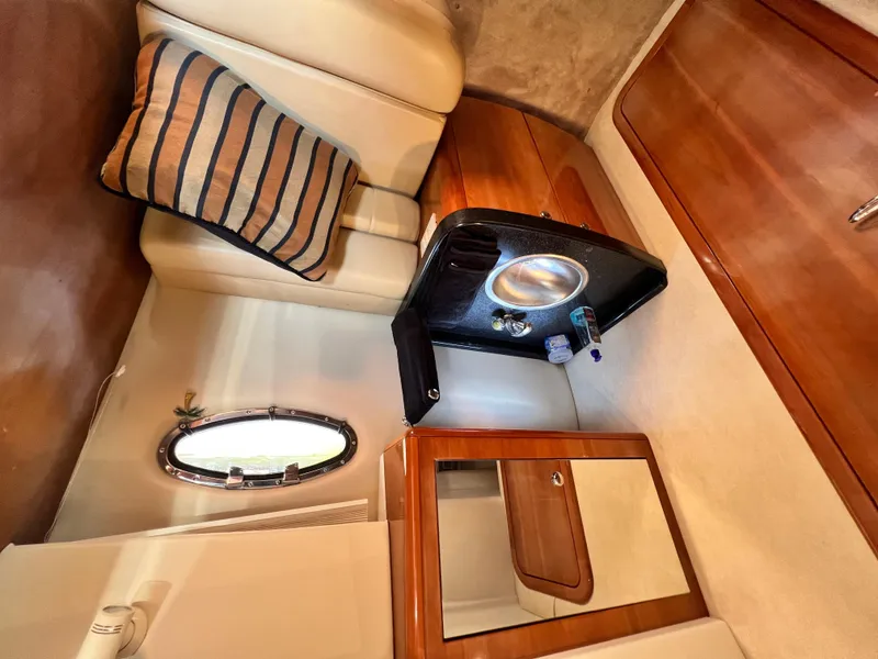 Slide: The Image of Interior of 2002 Regal Commodore 4260 yacht with sink, mirror, and striped pillow. - 25