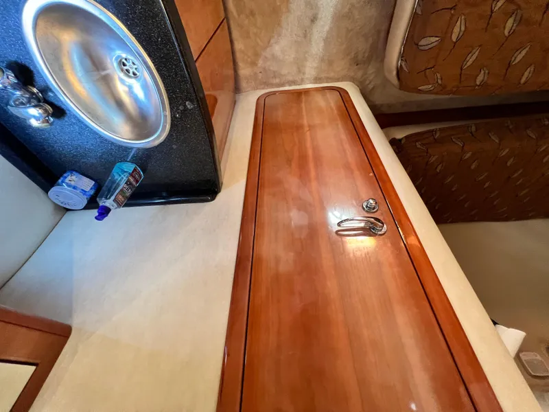 Slide: The Image of Interior of 2002 Regal Commodore 4260 yacht with sink and wooden cabinetry. - 26