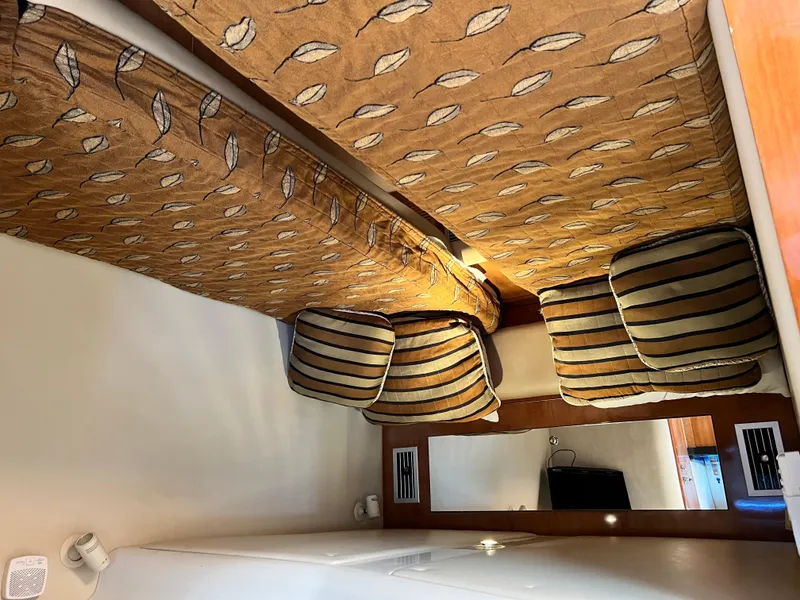 Slide: The Image of Interior of 2002 Regal Commodore 4260 with patterned cushions and wooden accents. - 27