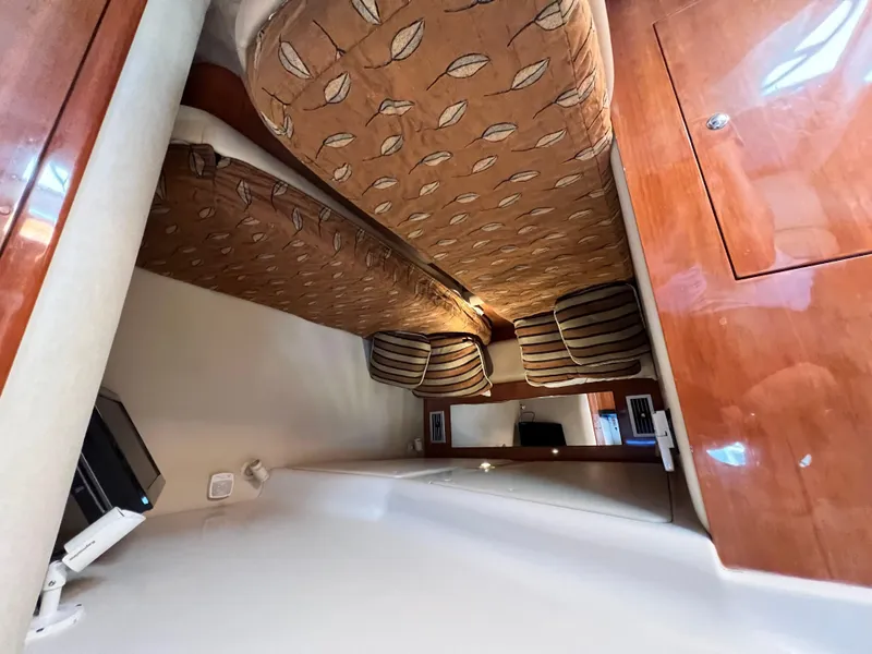 Slide: The Image of Interior cabin of 2002 Regal Commodore 4260 yacht with patterned upholstery and wooden cabinetry. - 28