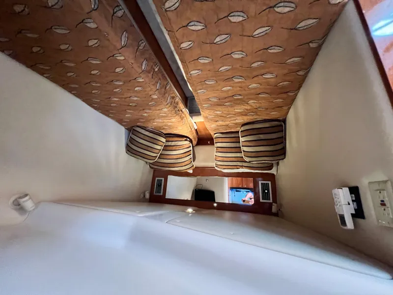 Slide: The Image of Interior cabin of 2002 Regal Commodore 4260 with patterned upholstery and striped cushions. - 29