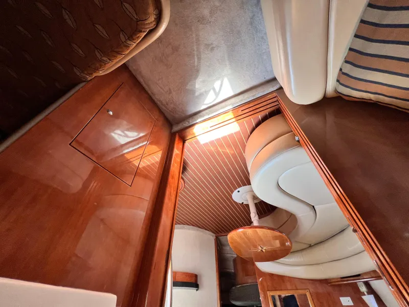 Slide: The Image of Interior of 2002 Regal Commodore 4260 yacht with wood paneling and leather seating. - 33