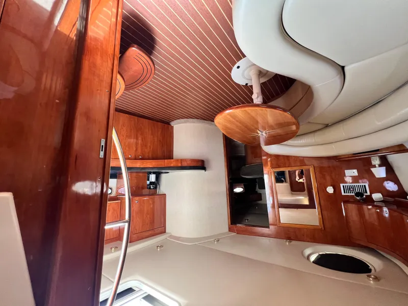 Slide: The Image of Luxurious interior of 2002 Regal Commodore 4260 yacht with wood finishes and seating area. - 34