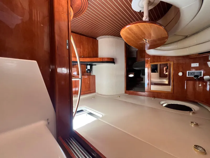 Slide: The Image of Interior of 2002 Regal Commodore 4260 yacht with wood finishes and modern amenities. - 35