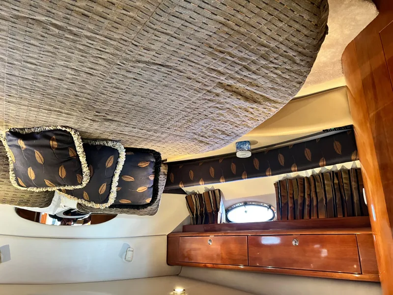 Slide: The Image of Luxurious interior of 2002 Regal Commodore 4260 yacht with elegant bedding and wood cabinetry. - 36