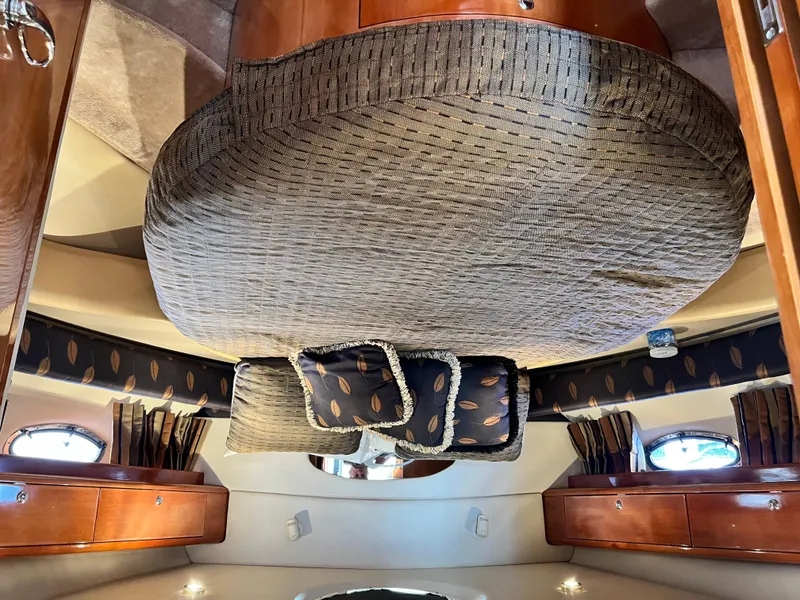 Slide: The Image of Luxurious interior of 2002 Regal Commodore 4260 yacht with elegant bedding and wood finishes. - 38