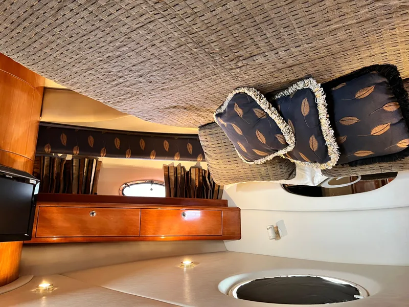 Slide: The Image of Luxurious interior of 2002 Regal Commodore 4260 yacht with elegant bedding and wood accents. - 39