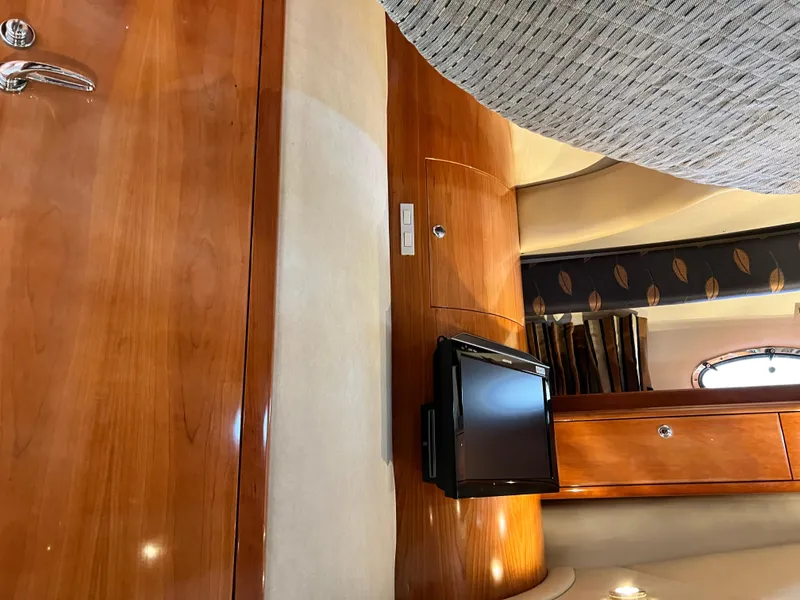 Slide: The Image of Interior of 2002 Regal Commodore 4260 yacht with wood paneling and mounted TV. - 40
