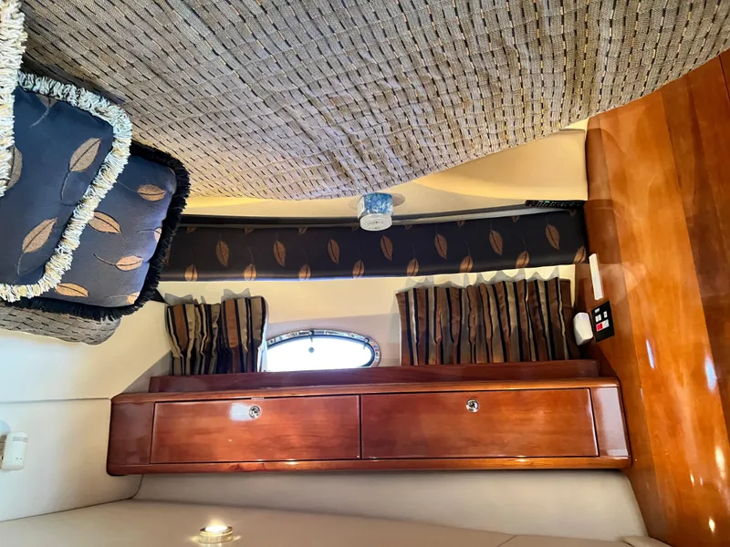 Slide: The Image of Interior of 2002 Regal Commodore 4260 yacht with wood cabinetry and patterned cushions. - 41