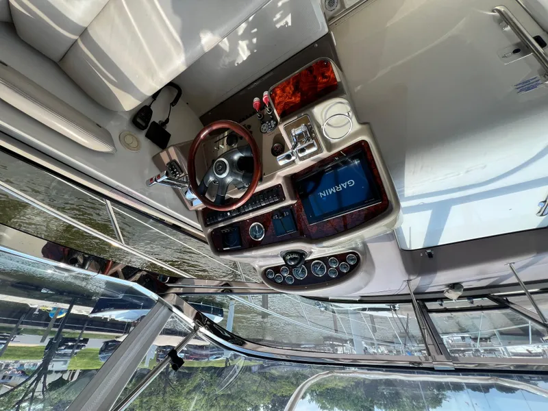 Slide: The Image of Cockpit of 2002 Regal Commodore 4260 with Garmin navigation and wood-trimmed steering wheel. - 43