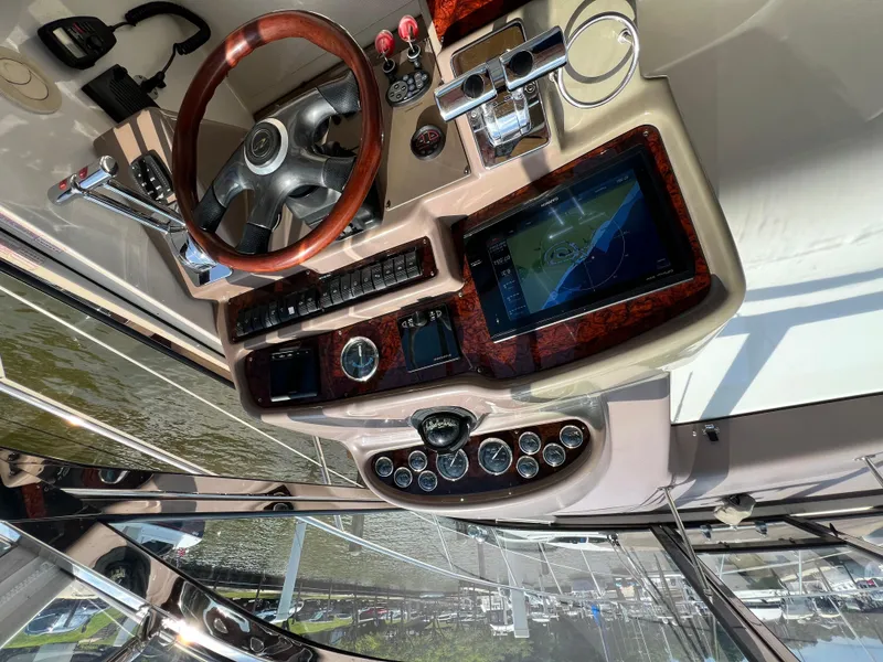 Slide: The Image of Helm of 2002 Regal Commodore 4260 with wood accents and navigation display. - 47