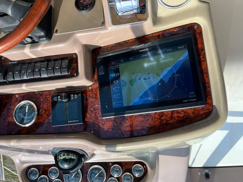 Slide: The Image of Control panel of 2002 Regal Commodore 4260 with navigation display and gauges. - 48
