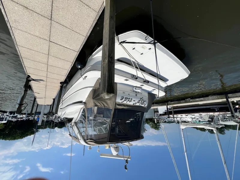 Slide: The Image of 2002 Regal Commodore 4260 yacht docked at marina, clear sky, calm water. - 5