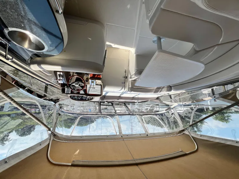Slide: The Image of Interior view of a 2002 Regal Commodore 4260 yacht cockpit with steering wheel and controls. - 6