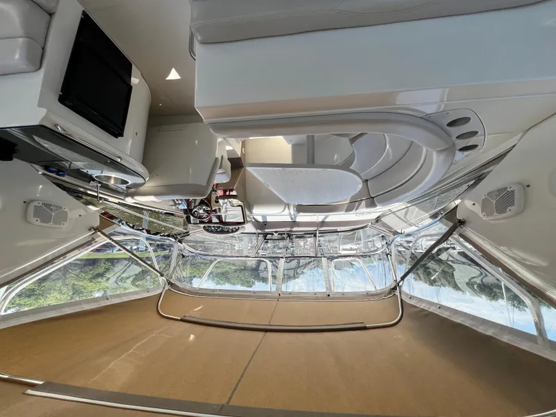 Slide: The Image of Interior of a 2002 Regal Commodore 4260 yacht, featuring seating and navigation area. - 9