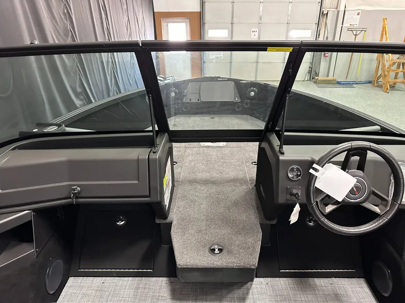 Slide: The Image of 2025 Alumacraft Trophy 175X Sport boat interior with steering wheel and dashboard. - 10