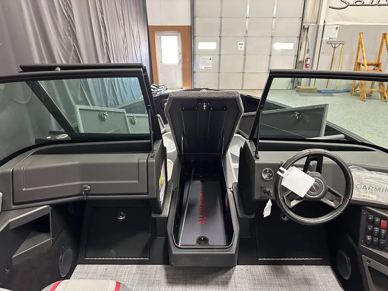 Slide: The Image of 2025 Alumacraft Trophy 175X Sport boat interior with open storage compartments. - 13