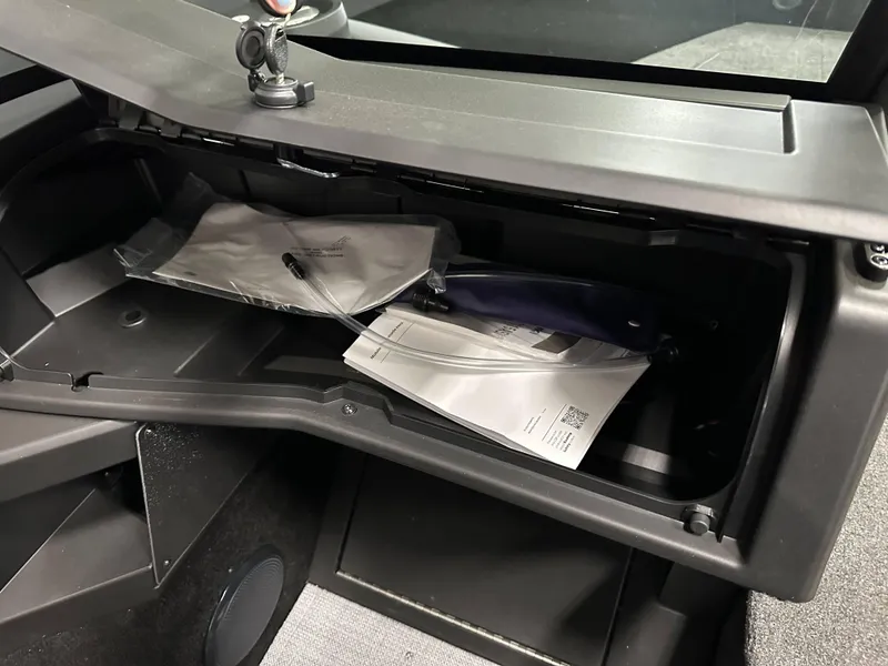 Slide: The Image of 2025 Alumacraft Trophy 175X Sport interior with cup holders and storage compartment. - 16