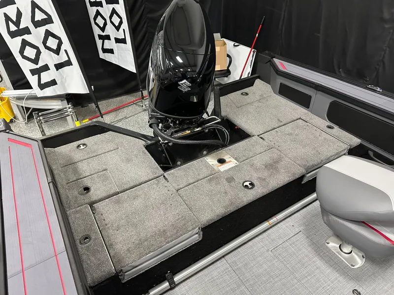 Slide: The Image of 2025 Alumacraft Trophy 175X Sport boat interior with gray carpet and storage compartments. - 29