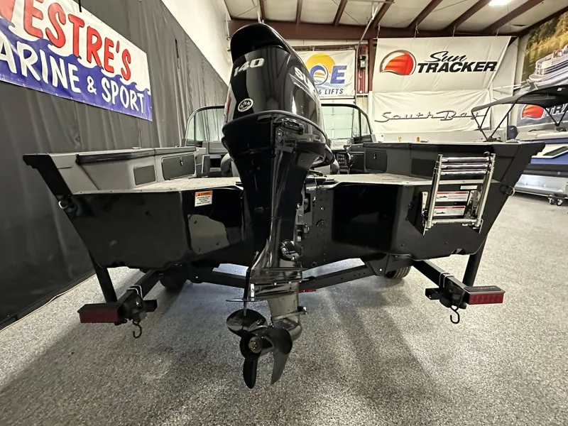 Slide: The Image of 2025 Alumacraft Trophy 175X Sport boat displayed indoors at a marine showroom. - 4