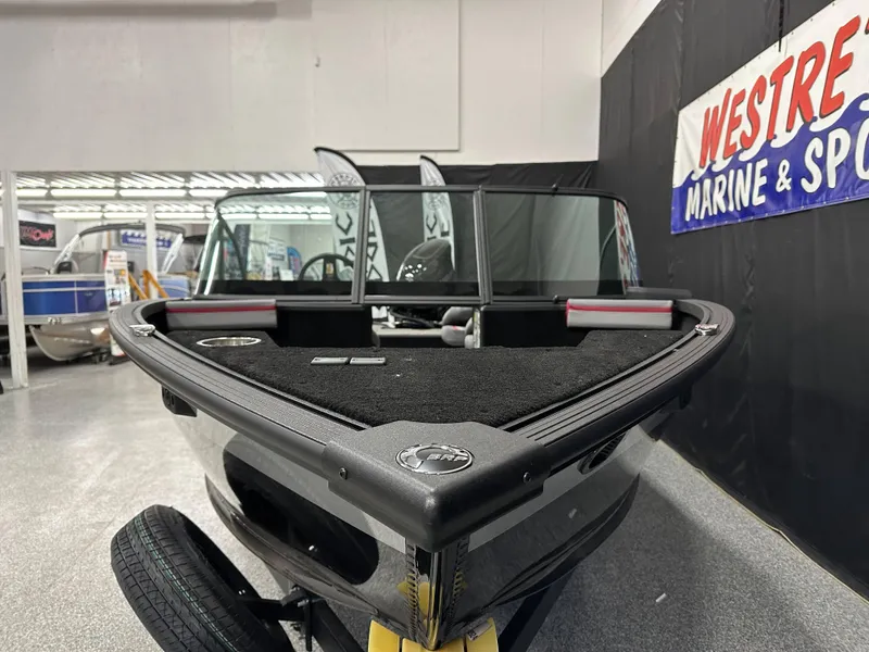 Slide: The Image of 2025 Alumacraft Trophy 175X Sport boat interior at a marine showroom. - 5