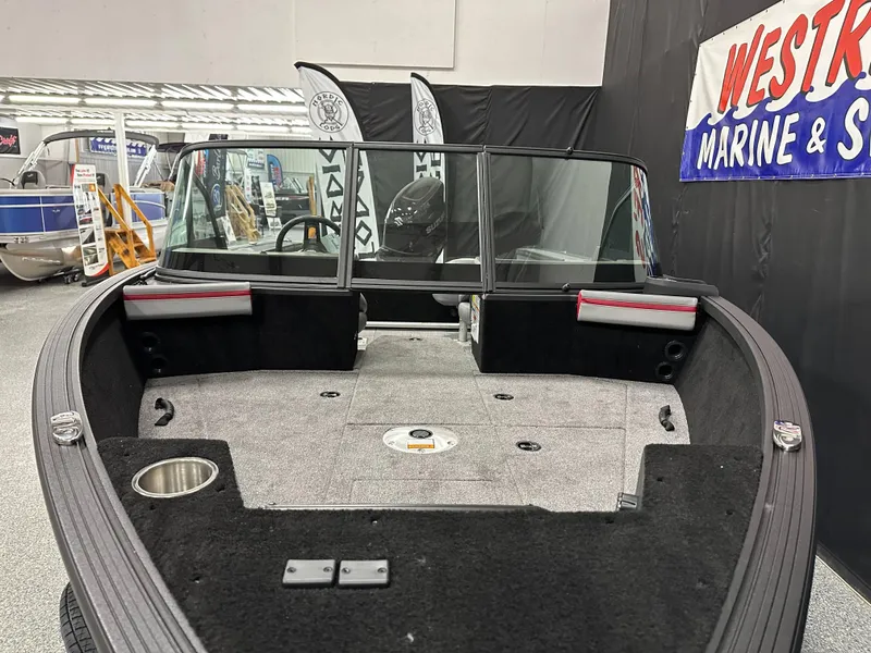 Slide: The Image of 2025 Alumacraft Trophy 175X Sport boat interior with carpeted deck and speaker system. - 6