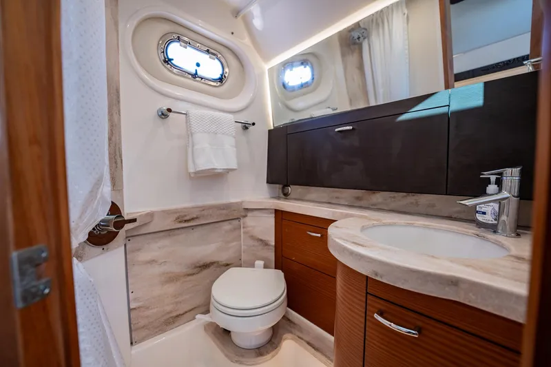 Slide: The Image of Luxurious bathroom in 2020 Pursuit S 408 Sport boat with modern fixtures and wood accents. - 18