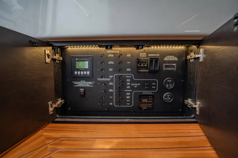 Slide: The Image of Control panel inside 2020 Pursuit S 408 Sport boat, featuring various switches and gauges. - 19