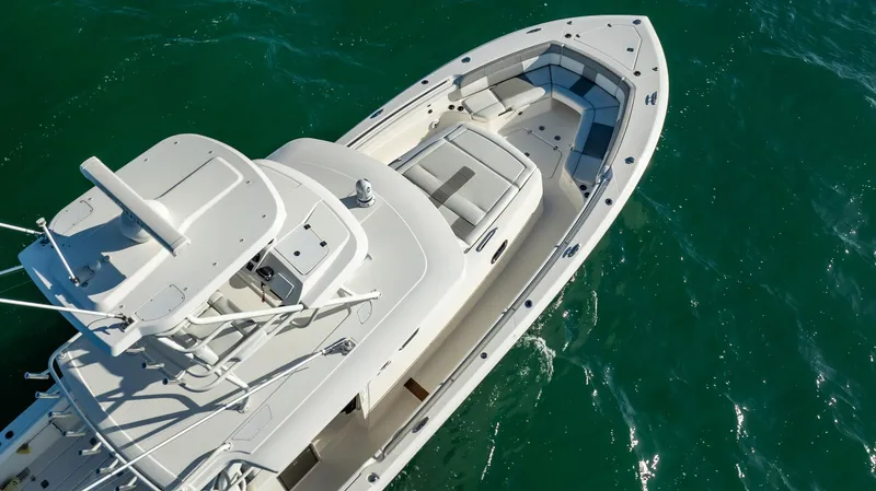 Slide: The Image of 2020 Pursuit S 408 Sport boat on clear blue water, aerial view. - 21