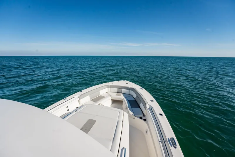Slide: The Image of 2020 Pursuit S 408 Sport boat on open sea under clear blue sky. - 27