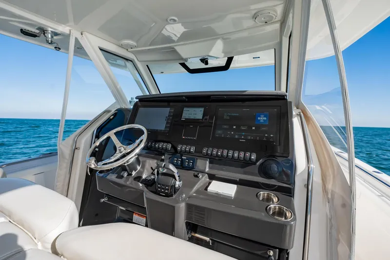 Slide: The Image of Cockpit of 2020 Pursuit S 408 Sport boat with modern controls and ocean view. - 29