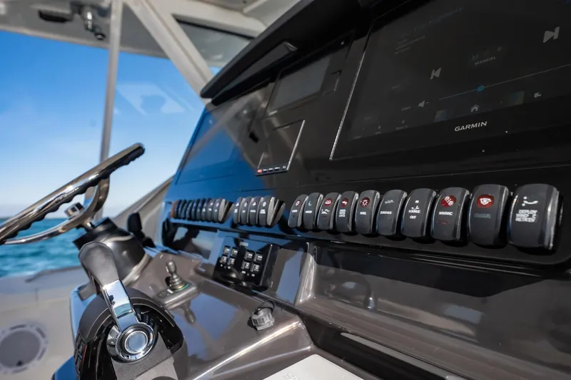 Slide: The Image of Control panel of 2020 Pursuit S 408 Sport boat with steering wheel and switches. - 30