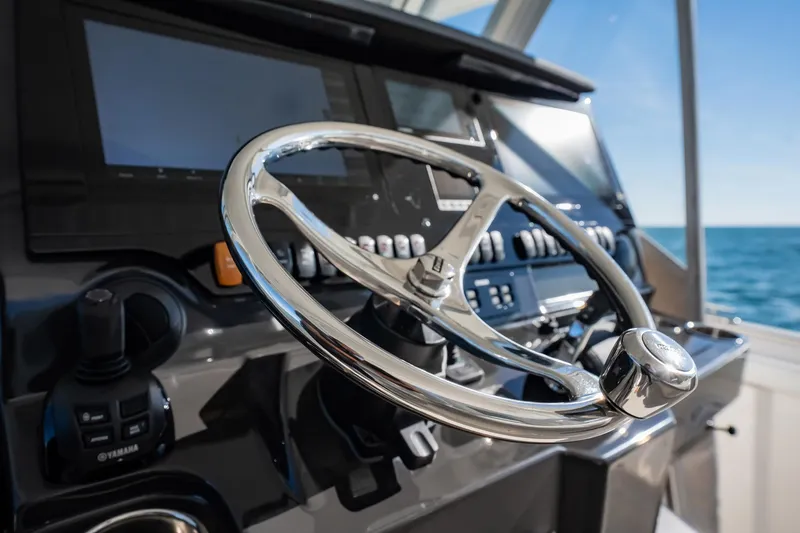 Slide: The Image of Steering wheel of 2020 Pursuit S 408 Sport boat with control panel. - 31