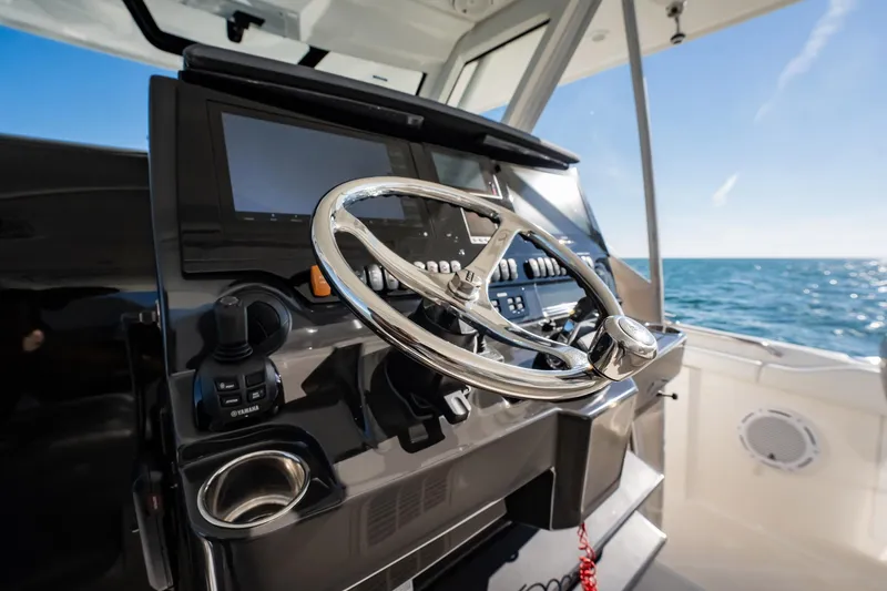 Slide: The Image of Helm of 2020 Pursuit S 408 Sport boat with ocean view. - 32