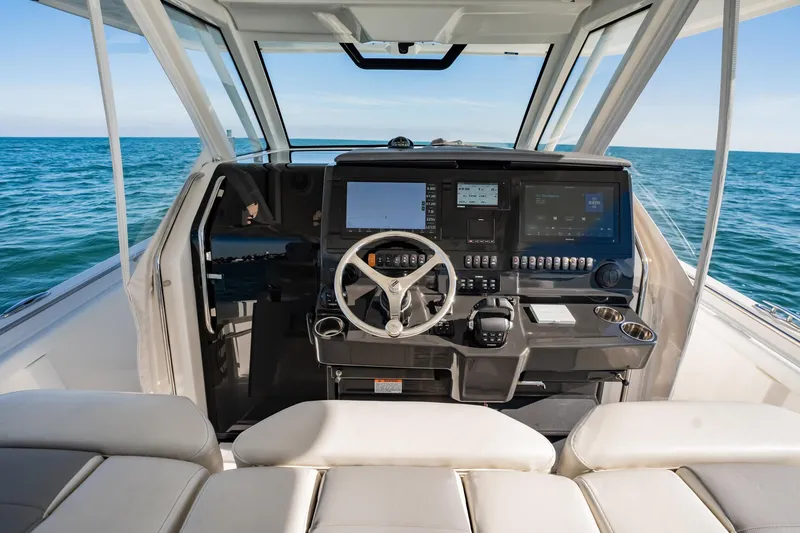 Slide: The Image of 2020 Pursuit S 408 Sport boat cockpit with advanced navigation system on open sea. - 34