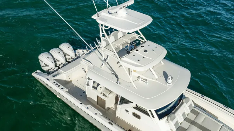 Slide: The Image of 2020 Pursuit S 408 Sport boat with triple engines on open water. - 36