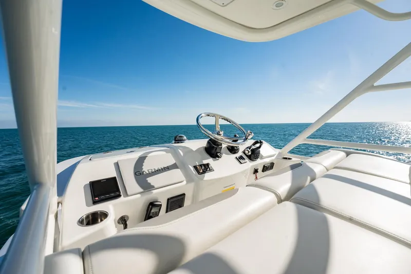Slide: The Image of 2020 Pursuit S 408 Sport boat helm with ocean view under clear blue sky. - 43