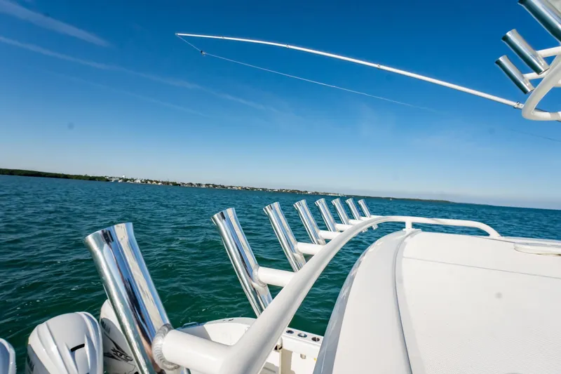 Slide: The Image of 2020 Pursuit S 408 Sport boat with fishing rod holders on open water. - 46