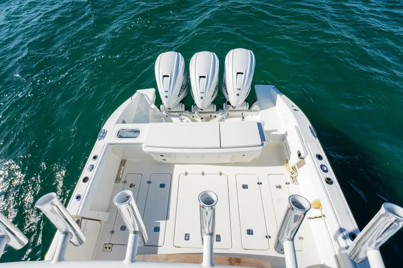 Slide: The Image of 2020 Pursuit S 408 Sport boat with triple engines on open water. - 47