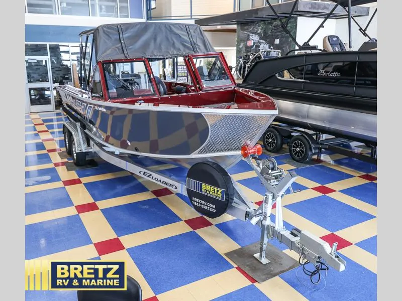 Slide: The Image of 2025 Evolution 221 boat displayed at Bretz RV & Marine showroom. - 1