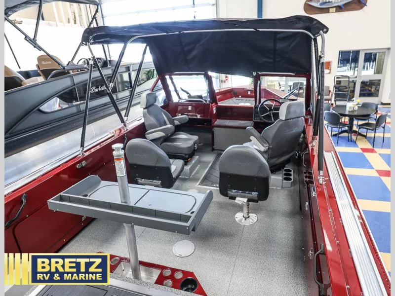 Slide: The Image of Interior of 2025 Evolution 221 boat with seating and canopy at Bretz RV & Marine showroom. - 10
