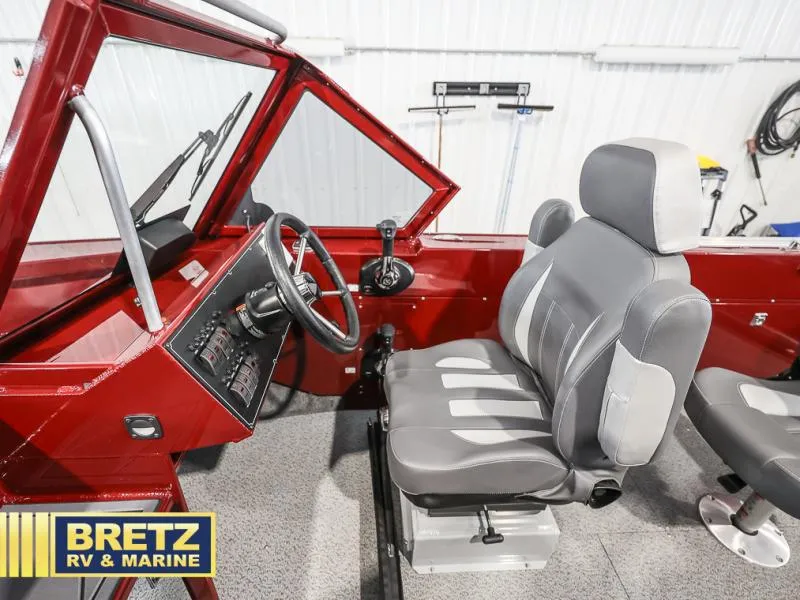 Slide: The Image of Interior of 2025 Evolution 221 boat with red dashboard and gray seating. - 11