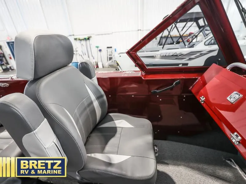 Slide: The Image of Interior of a 2025 Evolution 221 boat with gray seating and red accents. - 14